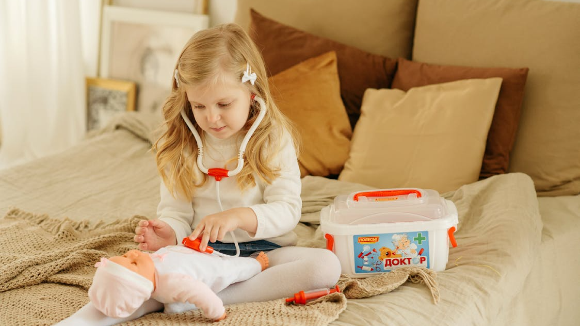 Girl 5 year old is playing with baby doll