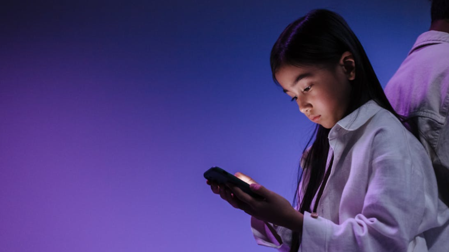 what age should a child get a phone parent guiding child using smartphone responsibly