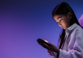 what age should a child get a phone parent guiding child using smartphone responsibly